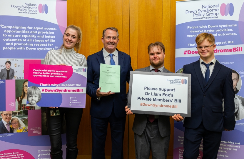 Dehenna Davison (left) pictured with Liam Fox MP holding signs showing support for the Down Sydrome Bill