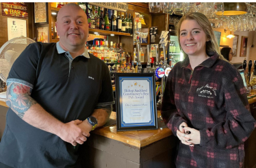 Dehenna and Landlord Tom Whipham at The Cricketers' Arms with certificate